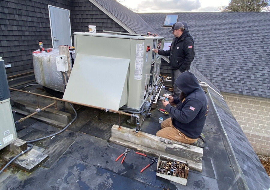 3c12f4fb-... — HVAC technician working on rooftop equipment